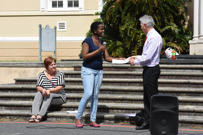 Safety, justice and healing: Student Kanyisa Ntombini, chair of UCT for Disability Justice, hands a list of demands to Vice-Chancellor Dr Max Price at a gathering outside Bremner Building on 26 January.