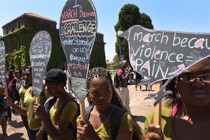 One voice: HIV/AIDS, Inclusivity & Change Unit's Agents of Change Educators lift their banners to support the SRC-lead 'There is No Excuse' campaign against harrassment, sexual violence, and rape.