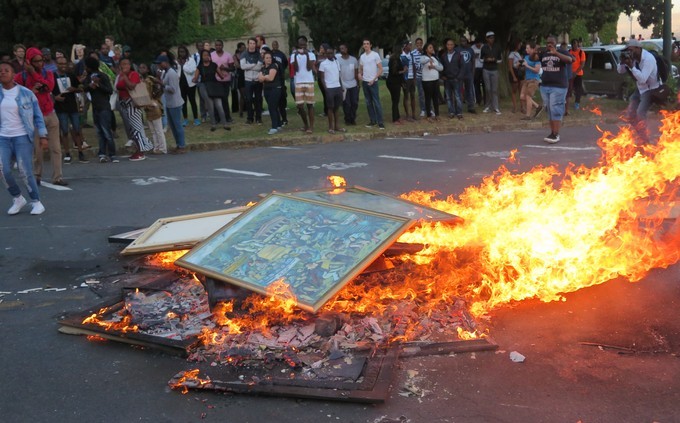 Political end: RMF members burn heritage paints on campus on 16 February, including works by Keresemore Richard Baholo.