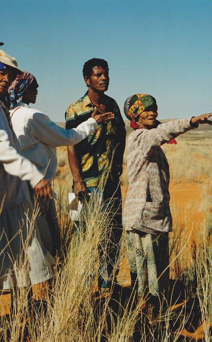 Kheis Brou, Una Rooi and Abaka Koper reconnect with their cultural heritage in the Kgalagadi Transfrontier Park. Here Abaka Koper points out something in the distance to Levi Namaseb.