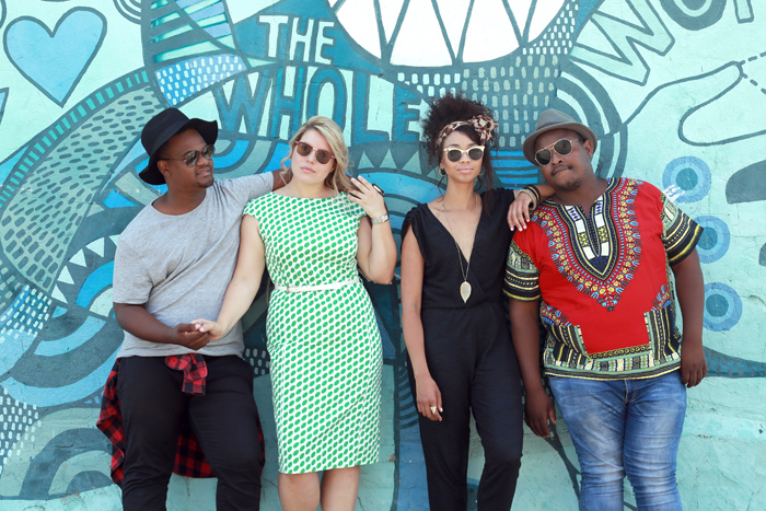 The romantic leads: Mimì, played by Amanda Osorio (polka dot dress), and Rodolfo, played by Given Nkosi (grey shirt); Marcello, played by Owen Metsileng (red African-print shirt), and Musetta, played by Lynelle Kenned (black jumpsuit).