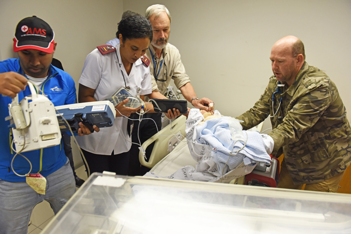Paramedics Shukri Petersen (far left) and Brian Allchin (far right) prepare to transfer a 'baby' as part of a simulation exercise. Handing over the patient are Nariema Fredericks and UCT's Prof Andrew Argent. Dummies are used to train medical personnel in the emergency care of infants and young children.
