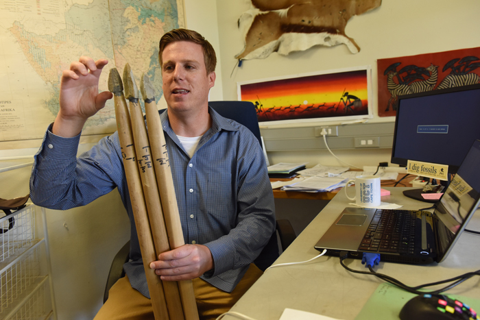 Postdoctoral research fellow in the Department of Archaeology, Dr Ben Schoville examines recreated Middle Stone Age stone points. Photo: Michael Hammond.