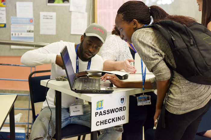 Students learn to set passwords on their new laptops, part of an initiative in which over 800 Lenovo computers were given to first-year students on financial aid at UCT.