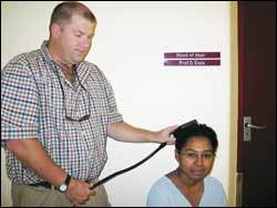 In her head: Prof Zig St Clair Gibson demonstrates the TMS on Mariama Stephens.