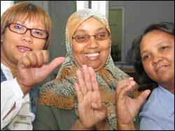 The A, B, C: (From left) Staffers Simona Adonis, Abiedah Abrahams, and Marie Pietersen flex their sign language alphabet skills.