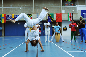 Africa Month kicked off on May Day with intra-varsity games in the Sports Centre. The theme - Celebrating Africa Through Sport - found fitting tribute, as indoor footballers celebrated goal after goal, while the court next door shook as basketball players slammed some impressive dunks. Teams played under the flags of various African countries, with the flags themselves draped above the courts. While the Keith Grainger Memorial UCT Open Squash Tournament was in full swing downstairs in the Sports Centre, Capoeiristas in the hall above displayed an array of gravity-defying moves. Photo by Michael Hammond.