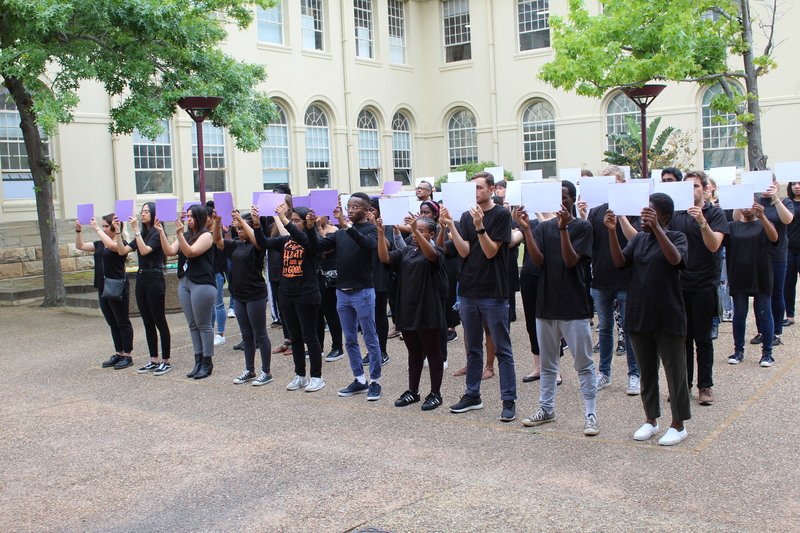 A team of staff and students in the Faculty of Health Sciences, in conjunction with the Gender Health and Justice Research Unit participating in an interactive poster campaign focusing on Intimate Partner Violence.
