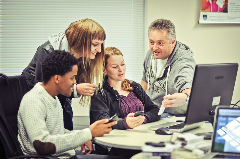 Where magic happens: (from left) Mohato Lekena (master's in computer science), Anja Venter (PhD in media studies), Sarah Brittan (master's in computer science) and Professor Gary Marsden (director of ICT4D Centre) at work in the lab.