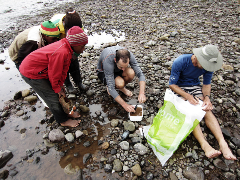 Curiouser and curiouser: Local Basotho boys watch Ian Durbach and Sam Jack conduct the daily diatom sampling along the river. (Photo James Puttick Photography.)