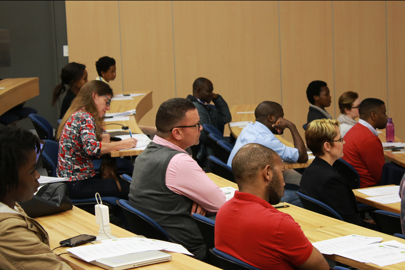 Participants listening to Three Minute Thesis competition entries.