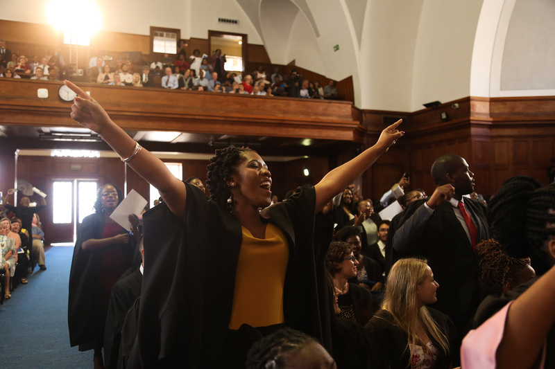 A graduand celebrates while an imbongi delivers a poem of praise to students, parents and teachers. <b>Photo</b>&nbsp;Je&rsquo;nine May.