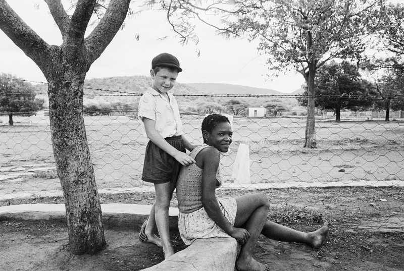 A farmer’s son with his nursemaid, Heimweeberg, Nietverdiend, Western Transvaal 1964. Photograph by David Goldblatt.