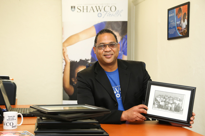 Gavin Joachims, director of SHAWCO, shows off one of the archival photographs, which span SHAWCO’s 75-year history.