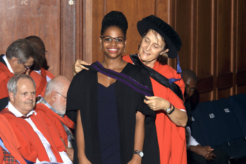 Luleka Dlamini (24), a former intern at UCT’s African Climate and Development Initiative (ACDI), is hooded by Deputy Registrar Dr Karen van Heerden. Dlamini is currently pursuing a master’s degree in Environmental and Geographical Science.