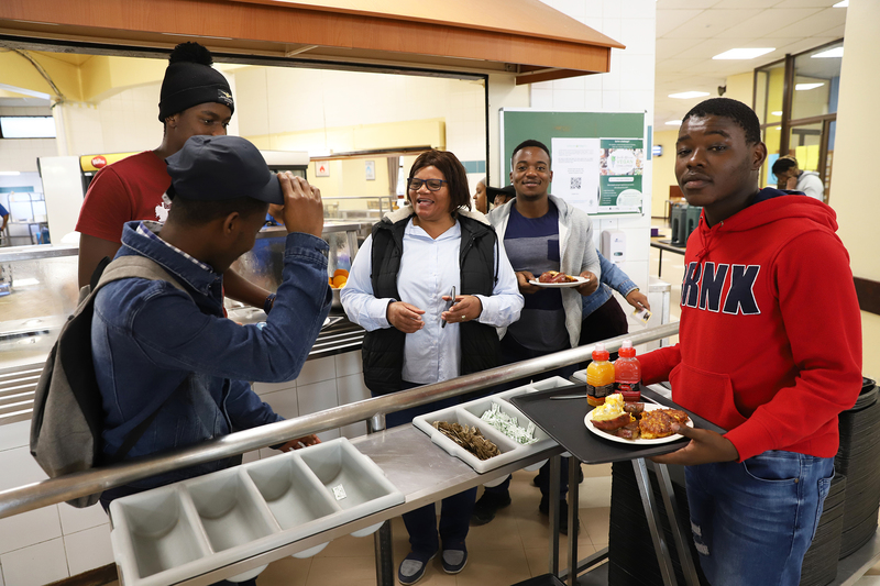 ”Mama Merle” Awkes doing what she does best; looking after the students who live at Leo Marquard Hall.