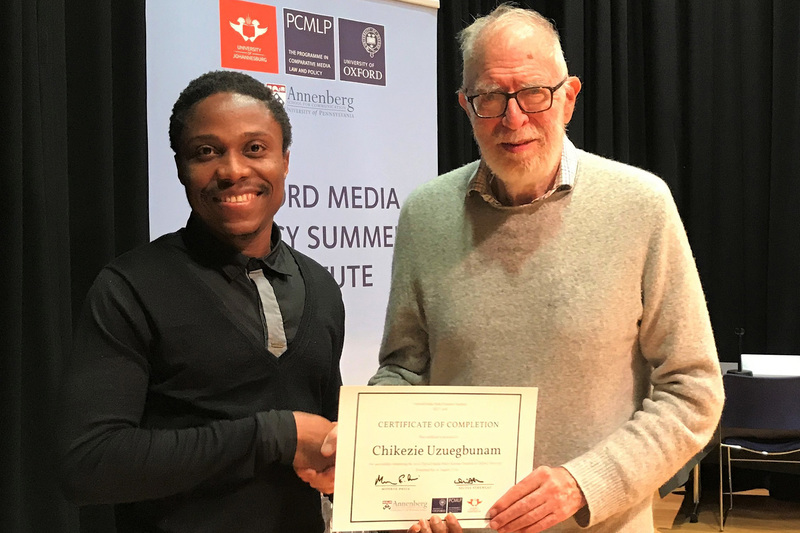 Doctoral student Chikezie Uzuegbunam receives his certificate of completion from Institute founder Professor Monroe Price.