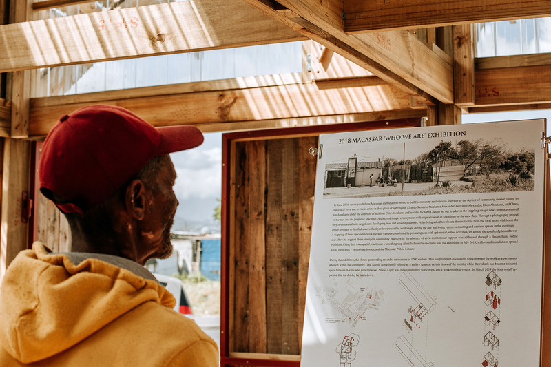 A Macassar resident engages with the exhibition at the opening of the common space.