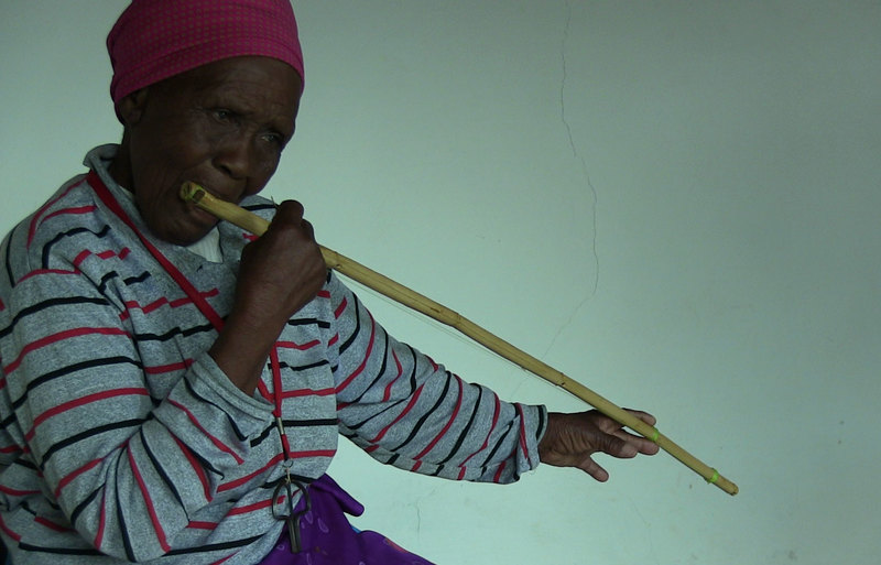 Matlali Khoane playing the lekope, a mouth-resonated bow.