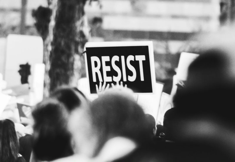 Communities were called on to use the COVID-19 pandemic to drive social change in the fourth conversation of the UCT Summer School series. <strong>Photo</strong> <a href="https://www.pexels.com/photo/monochrome-photo-of-resist-signage-3141240/" target="_blank">Pexels</a>.