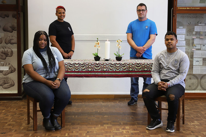 (From left, back) Shirees Benjamin and Michael Cassar, with (front) Megan Petersen and Jacques Jacobs, members of the team that manages UCT’s body donor programme. A memorial candle is usually lit as part of the annual student-led body donor memorialisation programme to honour those who bequeathed their bodies for dissections. This year the ceremony was marked virtually in the form of a video.