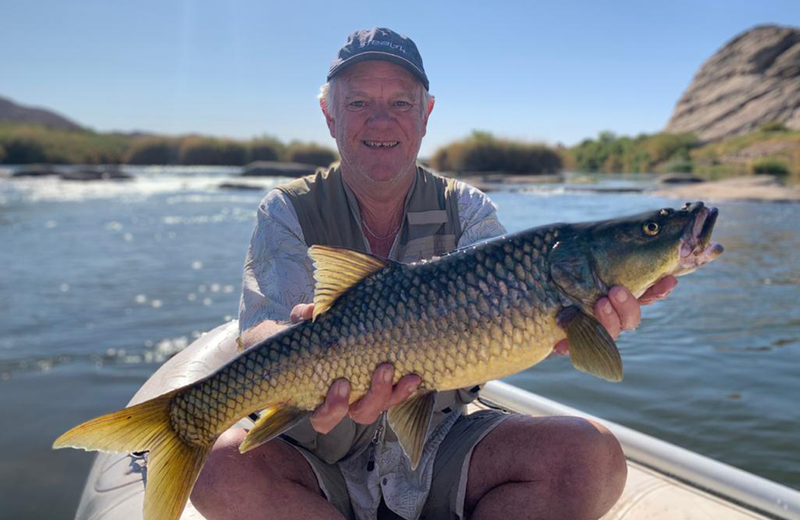 The one that didn’t get away – Dr Rob Little with a largemouth yellowfish, caught on the Orange River. <b>Photo</b> Grant Cannon.