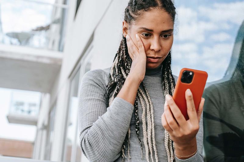 Prof Herman Wasserman will be leading a global study on disinformation, which is deliberately created to harm a person, social group, organisation or country. <strong>Photo</strong> <a href="https://www.pexels.com/photo/crop-concerned-black-woman-using-smartphone-on-street-5700200/" target="_blank">Alex Green / Pexels</a>.