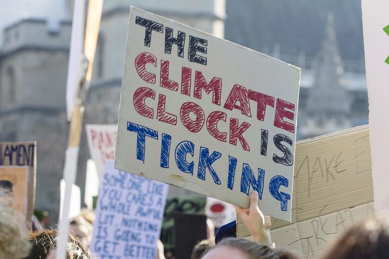 Dr Christopher Trisos set up the Climate Risk Lab at UCT, which integrates data and methods from environmental and social sciences to help inform rapid, just and equitable responses to the climate crisis. <b>Photo</b> <a href="https://stock.adobe.com/images/protestors-holding-climate-change-banners-at-a-protest/249820507" target="_blank">Adobe Stock</a>. 