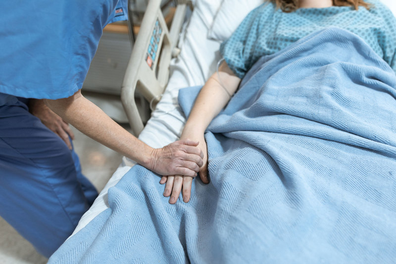 Existing early detection systems have compromised nurses&rsquo; responses by resulting in no response at all, or a delayed response in calling for assistance. <strong>Photo</strong> <a href="https://www.pexels.com/photo/man-in-blue-shirt-holding-woman-in-blue-dress-6129685/" target="_blank">RODNAE Productions / Pexels</a>.
