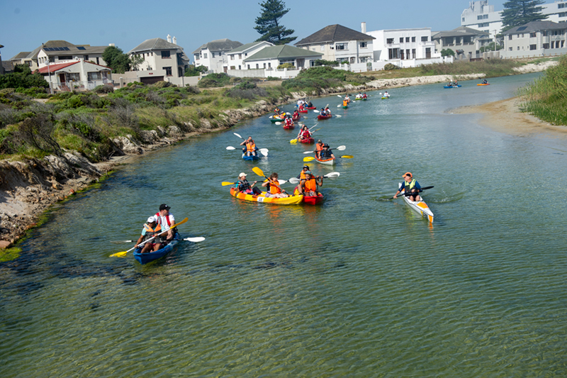 The flotilla of kayaks makes its way along Zandvlei, battling strong winds and occasional sandbanks in the shallows. <b>Photo</b> Lerato Maduna.