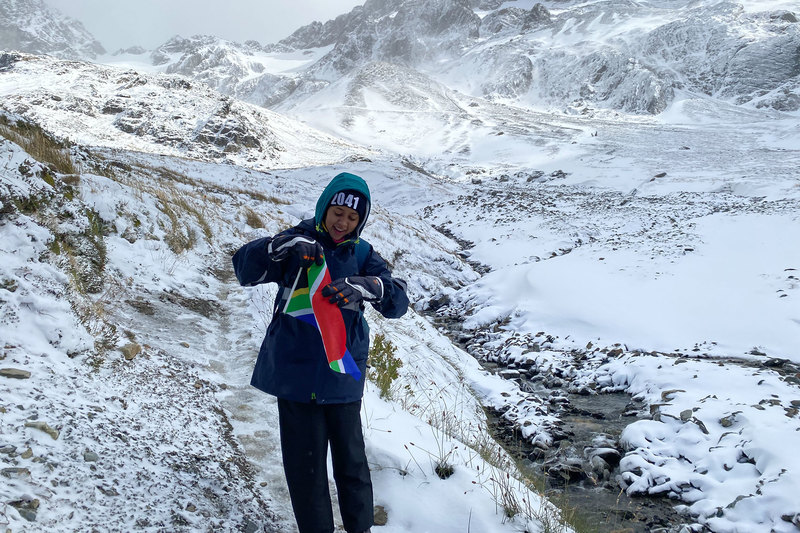 Catherine Dunn unfurls her South African flag in Ushaia, Argentina, the first leg of the 2041 ClimateForce Antarctic expedition to the frozen continent.