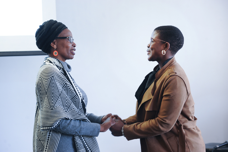 Ayabulela Mhlahlo (right), the first recipient of the Rhodes Must Fall (RMF) Scholarship, is congratulated by DVC for Transformation, Student Affairs and Social Responsiveness Prof Elelwani Ramugondo.