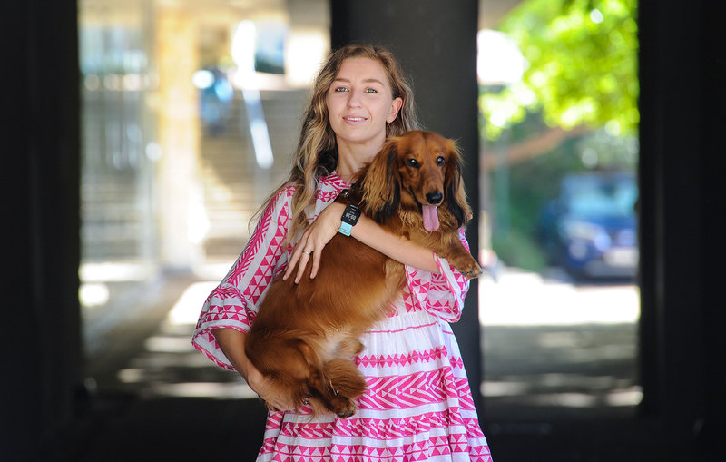 PhD graduand Caitlin Courtney’s dissertation received rave reviews. Here she is with her most dogged supporter, Ralph the long-haired sausage dog, who earned a special mention in her acknowledgements. <b>Photo</b> Lerato Maduna.