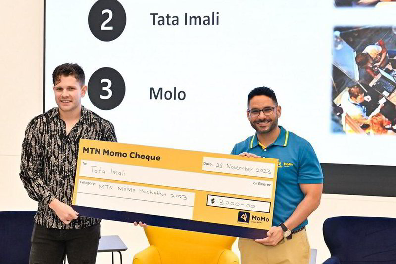Gregory Andrews (left), CEO and founder of Tata-iMali, collects the second prize in the MTN MoMo Hackathon 2023 on behalf of his team. 