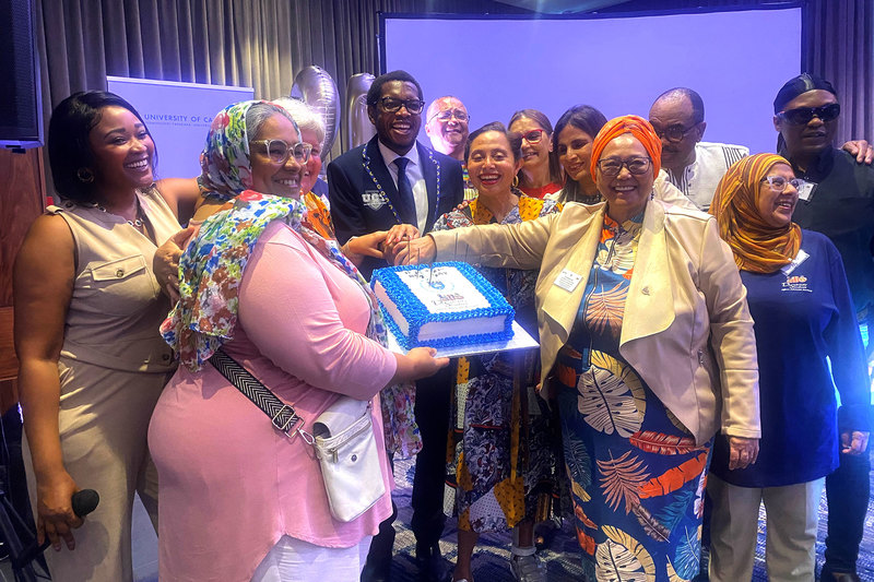 Staff in the Division of Disability Studies and others join VC Prof Mosa Moshabela to cut the 21st birthday cake. <b>Photo</b> Niémah Davids. 