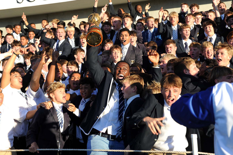 UCT Ikeys captain Sipho Dyonase celebrates the Varsity Cup win with learners at SACS as part of their trophy parade to local schools.