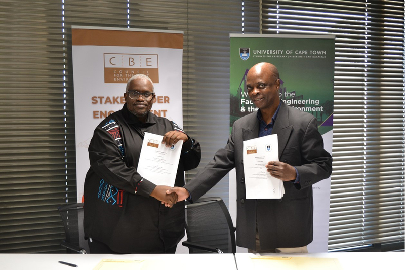 Dr Msizi Myeza (left) and Prof Aubrey Mainza celebrate the signing of the agreement between UCT and CBE.