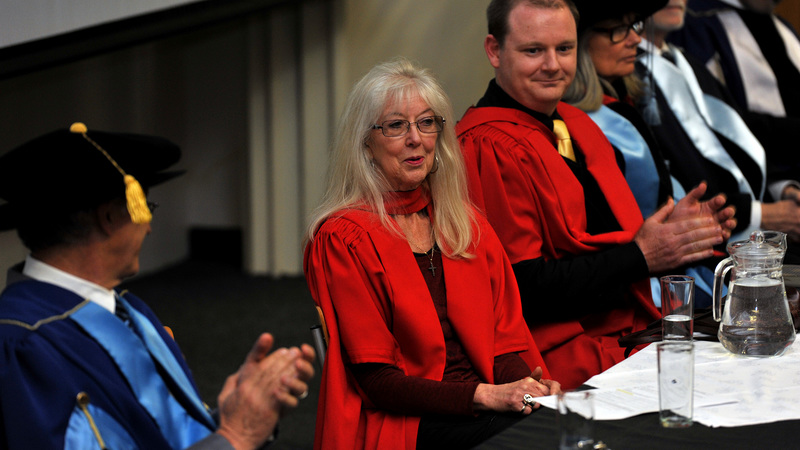 Colleagues applaud Prof Jennifer Roeleveld (centre) after she delivered her inaugural lecture about the impending tsunami that is information exchange. On her left is her co-researcher in the field of international tax, Assoc Prof Craig West.