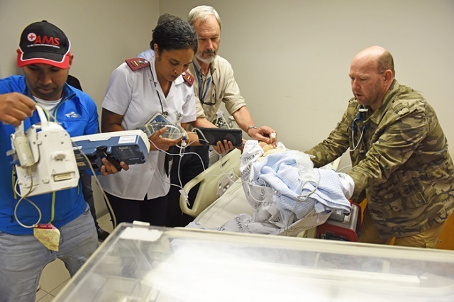 Paramedics Shukri Petersen (far left) and Brian Allchin (far right) prepare to transfer a ‘baby’ as part of a simulation exercise. Handing over the patient are Nariema Fredericks and UCT’s Prof Andrew Argent. Dummies are used to train medical personnel in the emergency care of infants and young children.