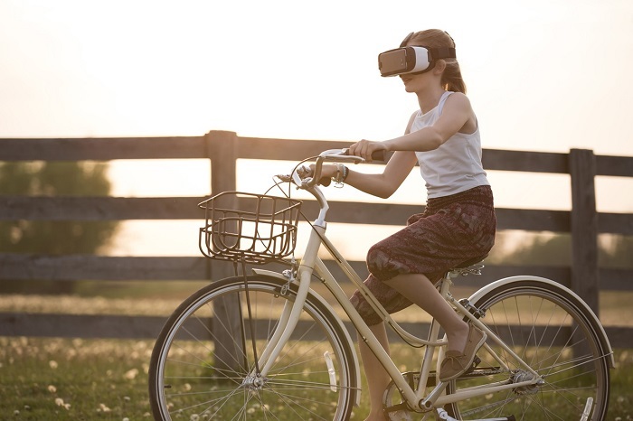 When it comes to children and virtual reality, proceed with caution. <a href="https://www.pexels.com/photo/girl-wearing-vr-box-driving-bicycle-during-golden-hour-166055/" target="_blank">Photo Sebastian Voortman</a>.