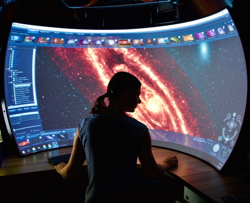 Dr Maria Kapala admiring an immersive view of the Andromeda Galaxy.