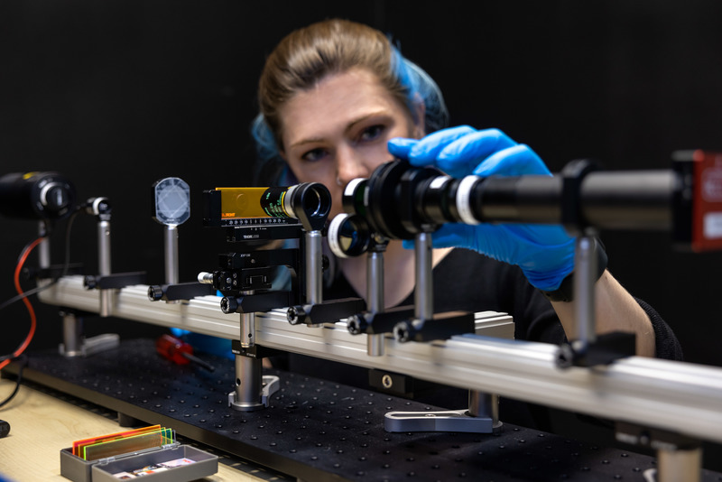 An Imaging Scientist adjusting the modular light path on a training microscope at the IDM Imaging Core Facility. <b>Photo</b>&nbsp;Migal Vanas.