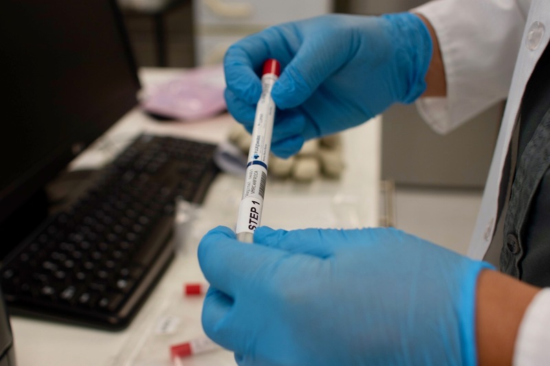 GIFT repository manager, Jacoeb Ganief, holds a vaginal swab from a study participant collection pack. Over the course of this study, each participant will provide several samples to be stored and catalogued at the GIFT repository. 