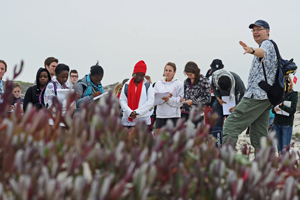 Dr Frank Eckardt (right) briefs students on data collection on the False Bay dunes