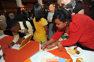 Learners sign copies of the new Child Gauge