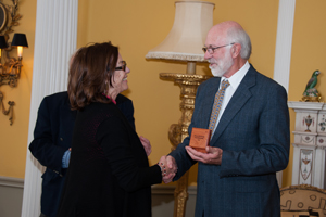 rof Les Underhill receives his award from Mary Slack