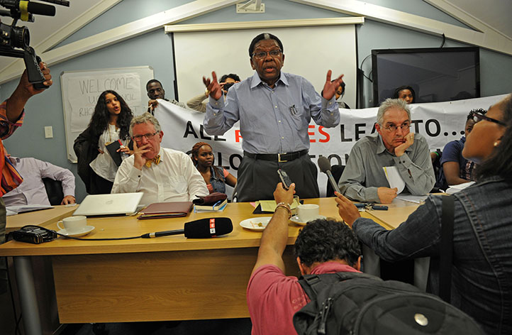 Chair of Council Archbishop Njongonkulu Ndungane addresses student protesters, who interrupted the Council meeting minutes before a vote on the removal of the statue was to take place. The stand-off came to an end when the majority of students left the meeting room, with only 15 remaining to witness Council unanimously voting for the removal of the statue. Photo by Michael Hammond.
