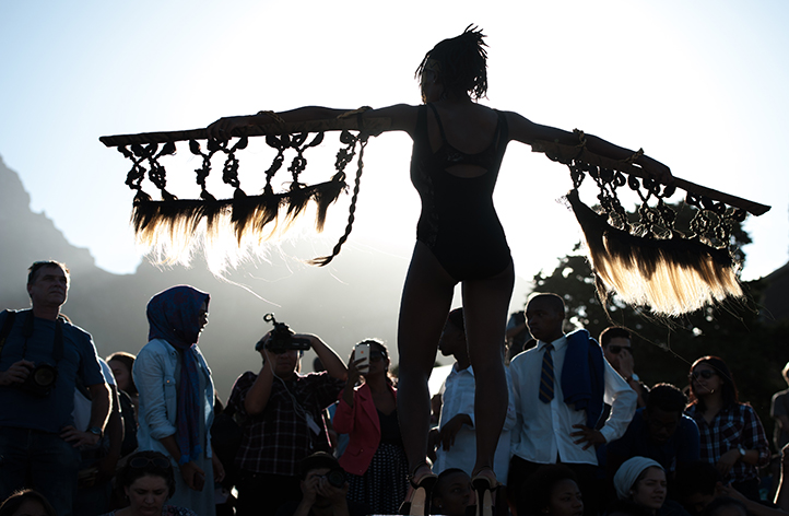 Artist Sethembile Msezane, currently pursuing her MFA degree at UCT, performing on the day the Rhodes statue came down. &ldquo;The statue needs to fall because it is not only damaging to black students and staff but also to white individuals because it fosters the thought that it is acceptable in a democratic South Africa to have and enact oppressive views, which is the legacy of colonialism.&rdquo;(<em>Elle</em>, 8 April 2015). Photo by Roger Sedres.