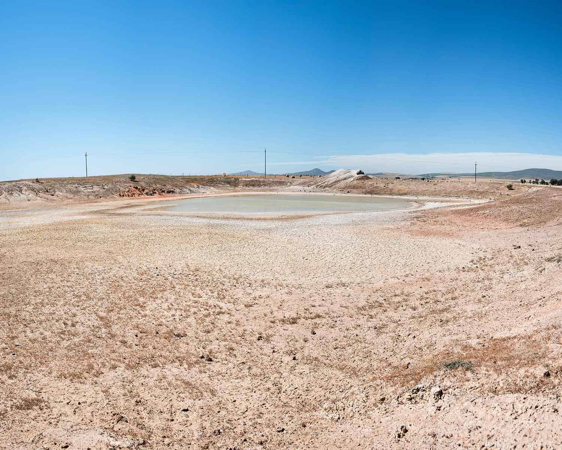 A dried-out dam, which speaks for itself, allows for the absurdity in the previous two images to be highlighted.
