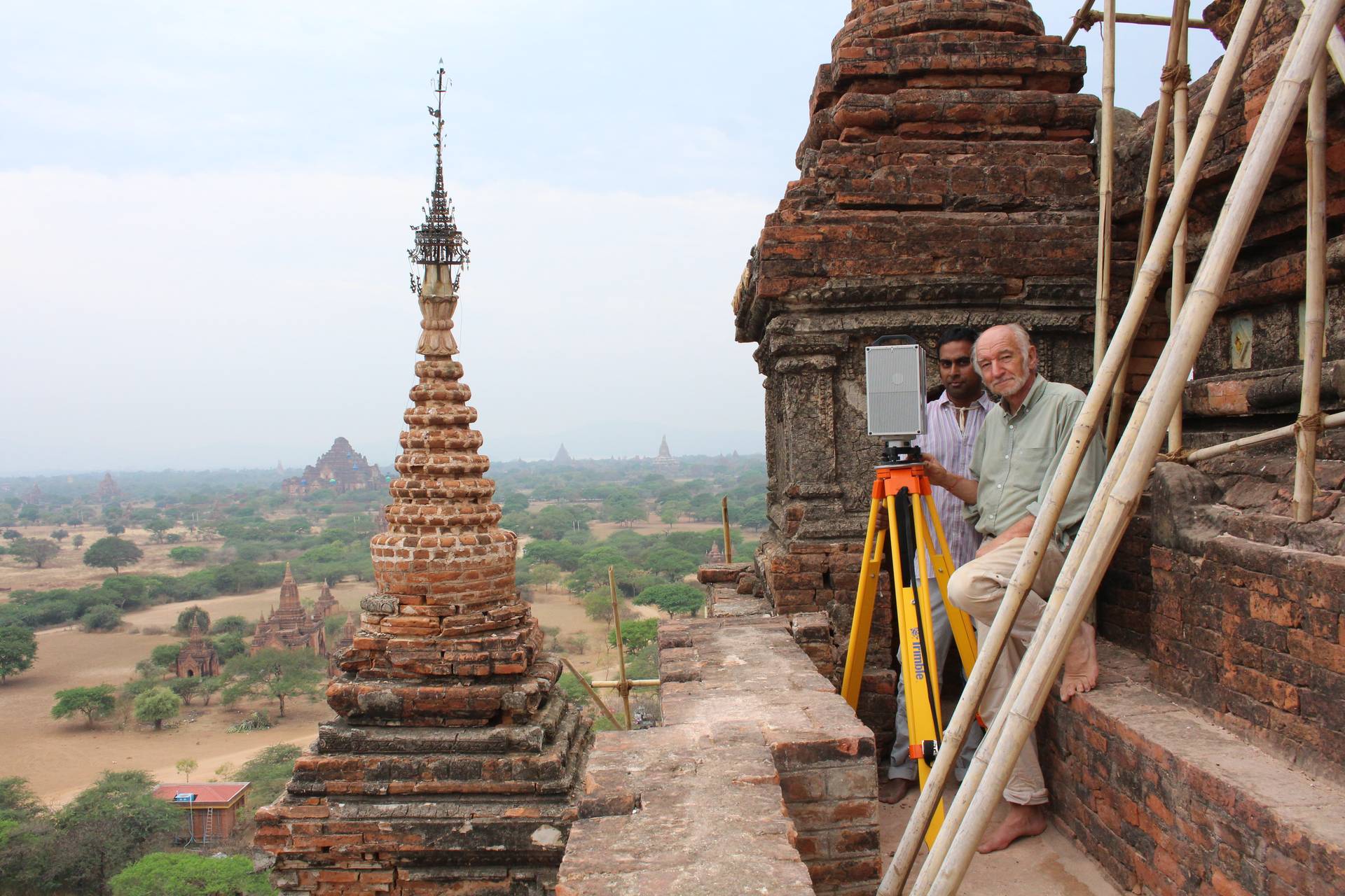 Discomfort was aggravated by splinters in hands and feet from the old, dry bamboo scaffolding. Still smiling are Emer Prof Heinz Ruther (front) and Roshan Bhurtha.